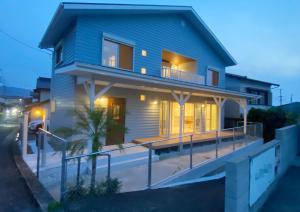 a blue house with a large deck at night at Karatsu seaside house - Vacation STAY 94789v in Karatsu