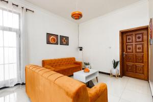 a living room with a couch and a table at Kigali great homes in Kigali