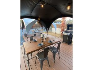 a table and chairs on a deck with a grill at ANKR VILLAGE KUJUKURI PRIVATE CAMP - Vacation STAY 93638v in Sammu