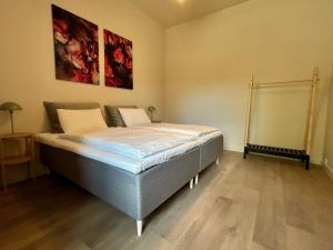 a bedroom with a bed in a room at Kalnamuiža Apartments in Smiltene +14 photos
