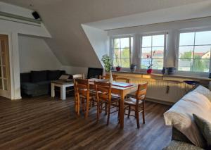 a living room with a table and chairs at MAIN Quartier in Kitzingen