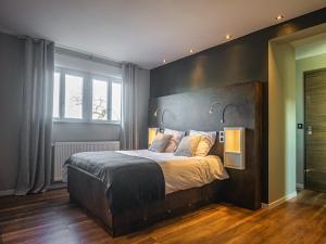 a bedroom with a large bed with two lamps on it at Spacious Stay in Lemberg in Lemberg