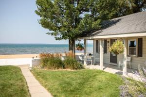 a house with a tree next to the beach at Lucky 7 at Lakeshore Resort in Traverse City