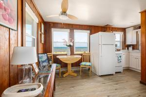 a kitchen with a refrigerator and a table with flowers at Lucky 7 at Lakeshore Resort in Traverse City