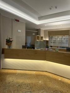 a lobby with a reception desk in a building at Abbazia Bed & Breakfast, MantegnaHotels in Mantova