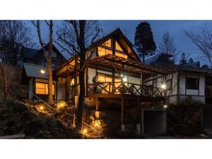 a house lit up at night with lights at Kurokawa Mori No Kiki - Vacation STAY 14710v in Aso