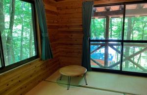 a room with a chair in front of a window at Hatto Furusato no Mori - Vacation STAY 21067v in Yamasaki