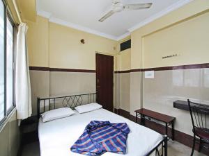 a bedroom with a bed with a blanket on it at Mayur Paradise in Bangalore +21 photos
