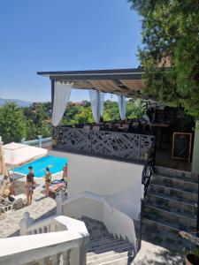a view of a swimming pool with two people in a resort at Garni Hotel Panorama Lux in Niš