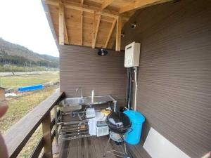 an outdoor kitchen with a sink and a stove at Unno Glamping - Vacation STAY 27780v in Nantan city