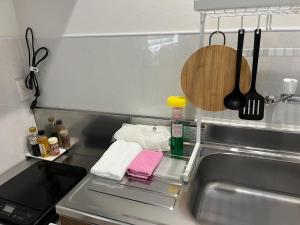 a kitchen sink with towels and utensils in it at MARINO1 - Vacation STAY 40074v in Fukuyama +14 photos