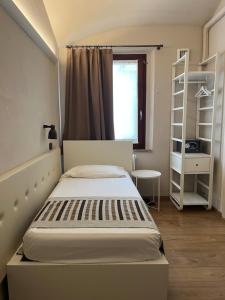 a small bedroom with a bed and a window at A Casa Dei Gonzaga, MantegnaHotels in Mantova +26 photos