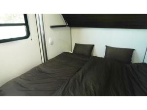 a bed in the corner of a room at OCEAN FRONT TATEYAMA - Vacation STAY 61320v in Tateyama