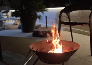 a fire pit with fire in it next to a chair at OCEAN FRONT TATEYAMA - Vacation STAY 61331v in Tateyama