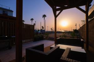 a patio with two chairs and a table at sunset at RUSH Awajiso - Vacation STAY 56534v in Awaji