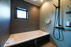a bath tub in a bathroom with a window at RUSH Awajiso - Vacation STAY 56534v in Awaji +22 photos