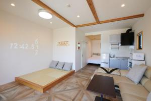 a living room with a couch and a kitchen at RUSH Awajiso - Vacation STAY 56534v in Awaji