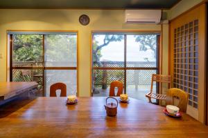 a dining room with a wooden table with cups on it at Chidorian - Vacation STAY 44553v in Awaji +16 photos