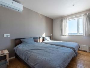 a bedroom with two beds and a large window at Buena Vista Tokachi - Vacation STAY 47319v in Obihiro +71 photos