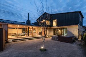 a house with a lot of windows and a tree at Kujukuri point 59 - Vacation STAY 49043v in Kujukuri