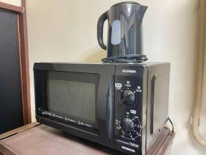 a microwave with a coffee pot on top of it at Shobi Building 2 208 - Vacation STAY 16685 in Tokyo