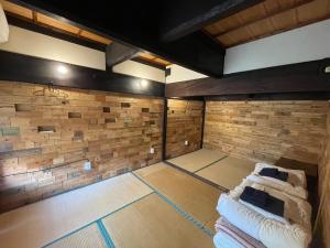 an empty room with brick walls and two beds at Tsudoi wo tsukuruyado Futatsuya - Vacation STAY 65957v in Ei