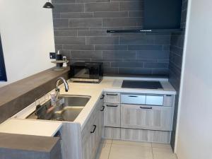 a small kitchen with a sink and a stove at KOYA TRIBE VILLA - Vacation STAY 63983v in Fujikawaguchiko