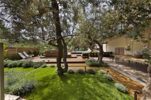 a garden with trees and a bench and grass at Villantonella in Sorrento