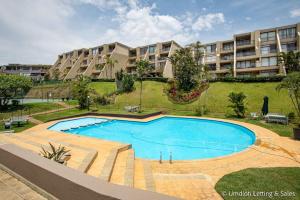 a large swimming pool in front of a building at C302 SURFSIDE in Umdloti