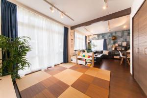 a living room with a checkered floor at Gajumaru no niwa - Itoman - Vacation STAY 16759 in Itoman