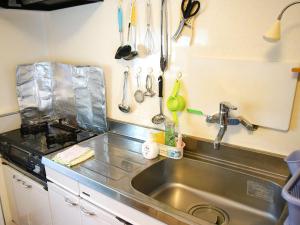 a kitchen with a stainless steel sink and utensils at Minshuku Kunya - Vacation STAY 70182v in Fukai +8 photos