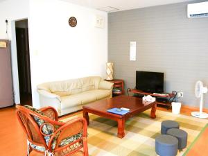a living room with a couch and a coffee table at Minshuku Kunya - Vacation STAY 70182v in Fukai