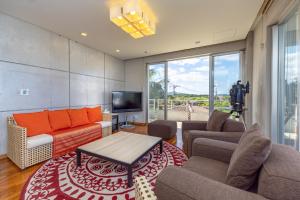 a living room with a couch and a tv at Andiamo Nosoko - Vacation STAY 73186v in Ibaruma