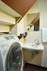 a washing machine and a sink in a room at Sapporo - House - Vacation STAY 16825 in Sapporo