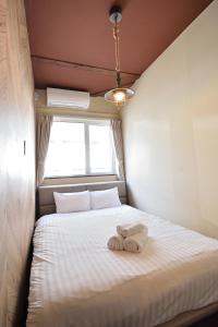 a bedroom with a bed with two towels on it at Sapporo - House - Vacation STAY 16825 in Sapporo