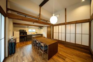 a kitchen with a wooden table in a room at Shuka - Vacation STAY 75085v in Aso
