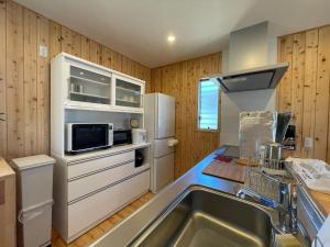 a kitchen with a sink and a refrigerator at Agrito Island Time - Vacation STAY 84454v in Imabari