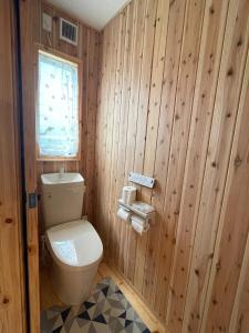 a bathroom with a toilet and wooden walls at Agrito Island Time - Vacation STAY 84454v in Imabari