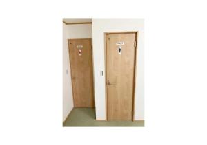 a corridor with two doors in a room at Travel Palace Miyuki - Vacation STAY 16813 in Kawaguchi