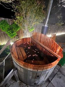 a wooden bucket filled with dirt in a yard at Asahi Sanso - Vacation STAY 16835 in Sosa +17 photos