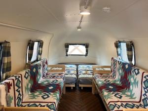 a room with two chairs and a bed in a trailer at CAMP & BEER BEERBELLY ISESHIMA - Vacation STAY 86412v in Shima