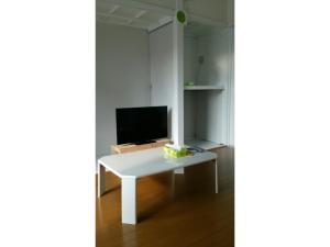 a white desk with a television on top of it at OYADO YAMASASHI - Vacation STAY 16886 in Ishigaki Island