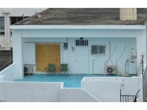 a view of a building with a patio with chairs at OYADO YAMASASHI - Vacation STAY 16886 in Ishigaki Island
