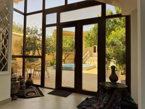 an open glass door with a view of a patio at Feruza guest house in Samarkand