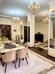 a living room with a dining table and chairs at Feruza guest house in Samarkand