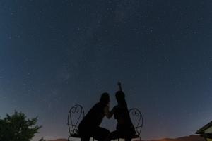 a couple sitting on a chair looking up at the stars at Blue Bear - Vacation STAY 16900 in Nagahama