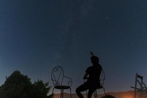 a man sitting on a chair looking up at the stars at Blue Bear - Vacation STAY 16900 in Nagahama