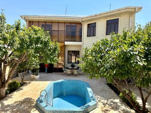 a blue couch in front of a house at Feruza guest house in Samarkand