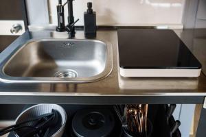 a kitchen counter with a sink and a stove at Hinata Surf Camp 108,110 - Vacation STAY 84402v in Hyuga +30 photos