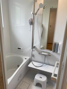 a bathroom with a shower and a tub and a sink at halcoya hanare - Vacation STAY 89587v in Shizukuishi
